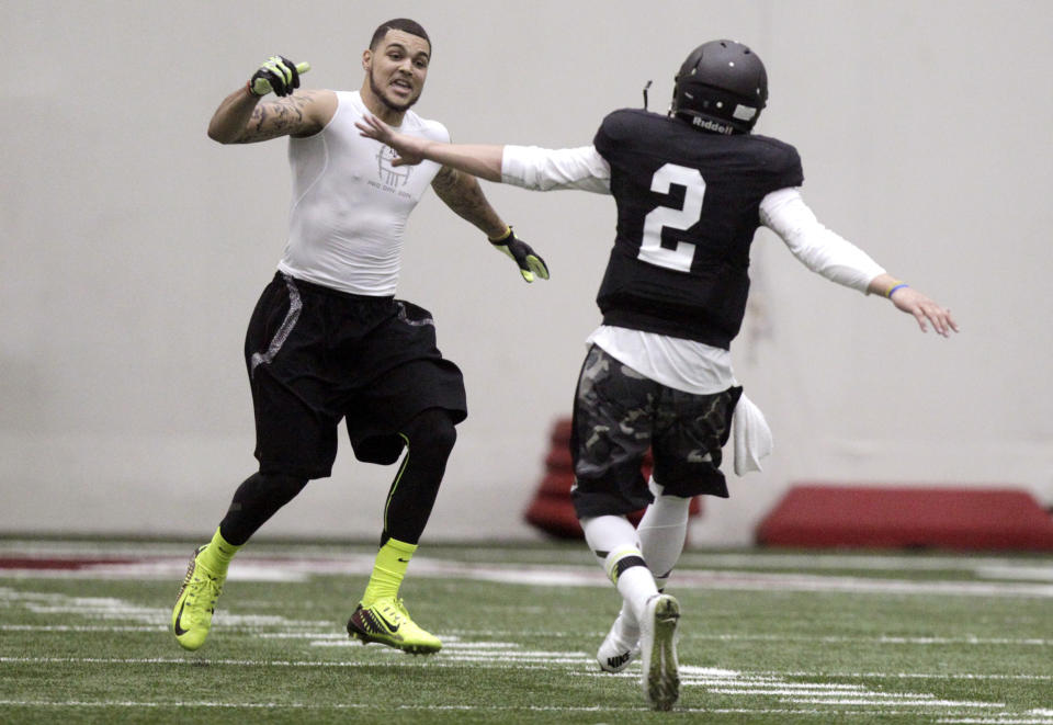 Texas A&M quarterback Johnny Manziel (2) and wide receiver Mike Evans celebrate after a pass reception during a drill at pro day for NFL football representatives in College Station, Texas, Thursday, March 27, 2014. (AP Photo/Patric Schneider)