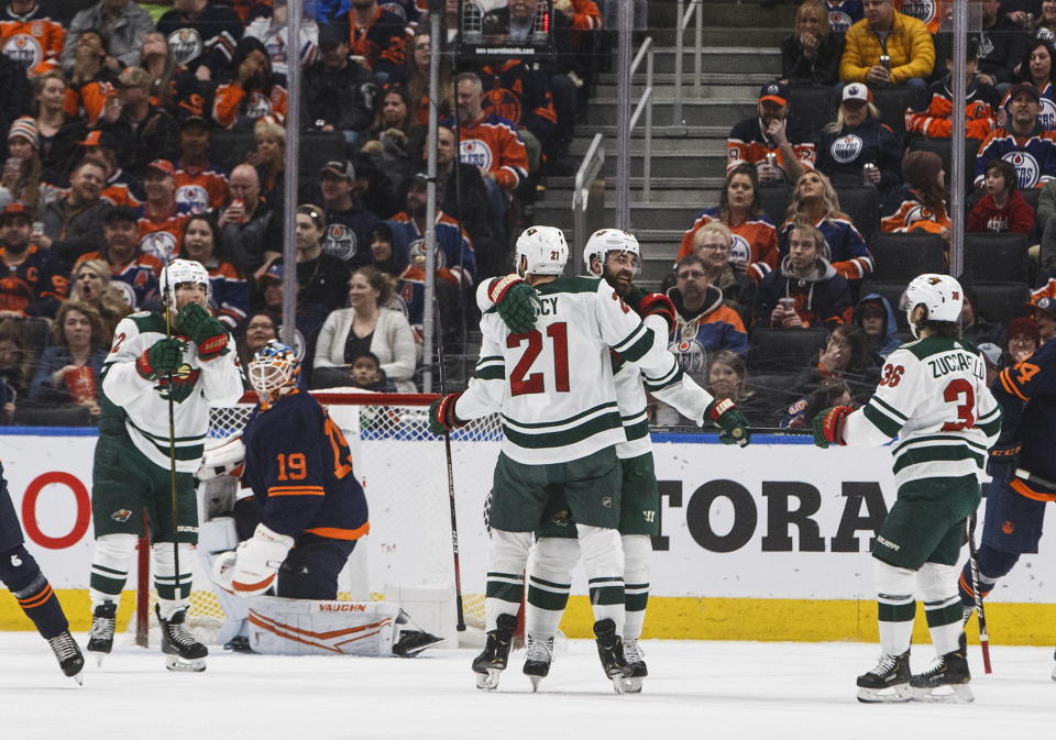 Minnesota Wild players celebrate a goal against Edmonton Oilers goalie Mikko Koskinen (19) lduring the second period of an NHL hockey game Friday, Feb. 21, 2020, in Edmonton, Alberta. (Jason Franson/The Canadian Press via AP)