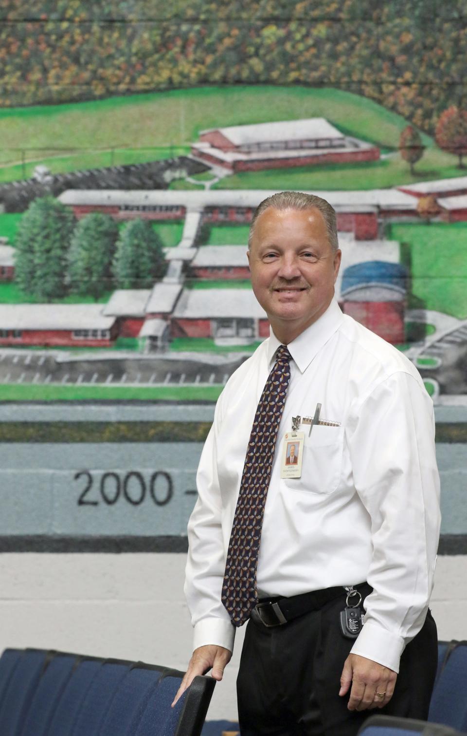 Principal James Montgomery poses near a mural of the school Thursday morning, Aug. 31, 2023, at Highland School of Technology.