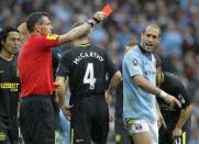 Referee Andre Marriner (L) shows Manchester City's defender Pablo Zabaleta (R) the red card to send him off after a challenge on Wigan Athletic's English striker Callum McManaman earned Zabaleta a second yellow card during the English FA Cup final at Wembley Stadium in London on May 11, 2013