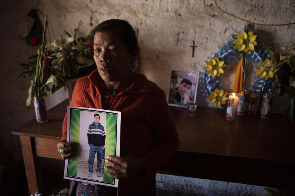 Elena Marroquin poses for a portrait with a photo of her grandson Rivaldo Danilo Jimenez, in her home in Comitancillo, Guatemala, Wednesday, Jan. 27, 2021. She believes that her grandson is one of the 13 of the 19 charred corpses found in a northern Mexico border state on Saturday. The country's Foreign Ministry said it was collecting DNA samples from a dozen relatives to see if there was a match with any of the bodies. (AP Photo/Oliver de Ros)