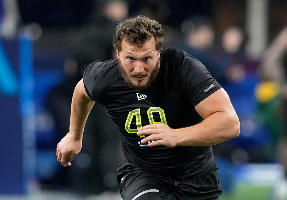 FILE - Chattanooga offensive lineman Cole Strange runs a drill during the NFL football scouting combine March 4, 2022, in Indianapolis. Strange was selected by the New England Patriots during the NFL draft Thursday, April 28. (AP Photo/Darron Cummings, File)