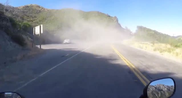 Alex headed throug the dust to find the driver was ok. Source: Storyful
