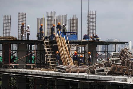 Construction labourers work at a building site in Bangkok June 18, 2014. REUTERS/Athit Perawongmetha