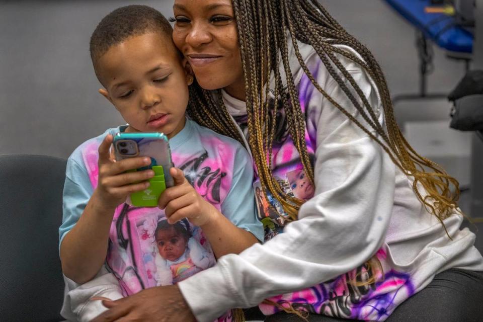 Marquisha Brown, 29, embraces her son Elijah during a visit to the Yolo County Children’s Alliance family resource center in West Sacramento on March 28, 2023. Brown said she worked for McDonald’s for a few months, eventually as a manager, but requests from Elijah’s school to pick him up would frequently disrupt her shift. She credits the Yolo Basic Income program for giving her the time to help her son heal from his trauma.