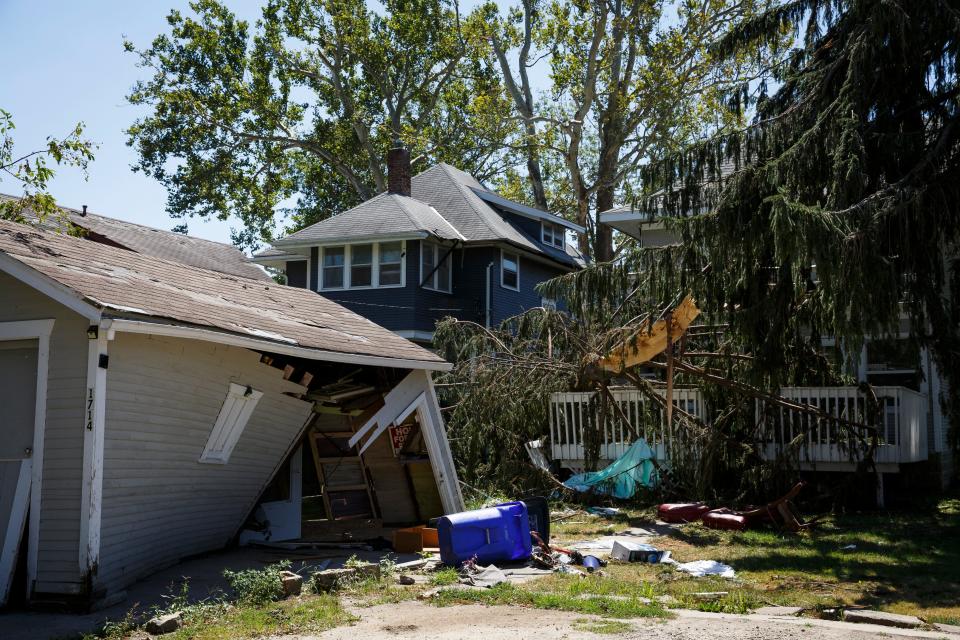 Trees remain toppled onto homes as Cedar Rapids residents continue to clean up and wait for power to be restored from last weeks Derecho on Wednesday, Aug. 19, 2020.