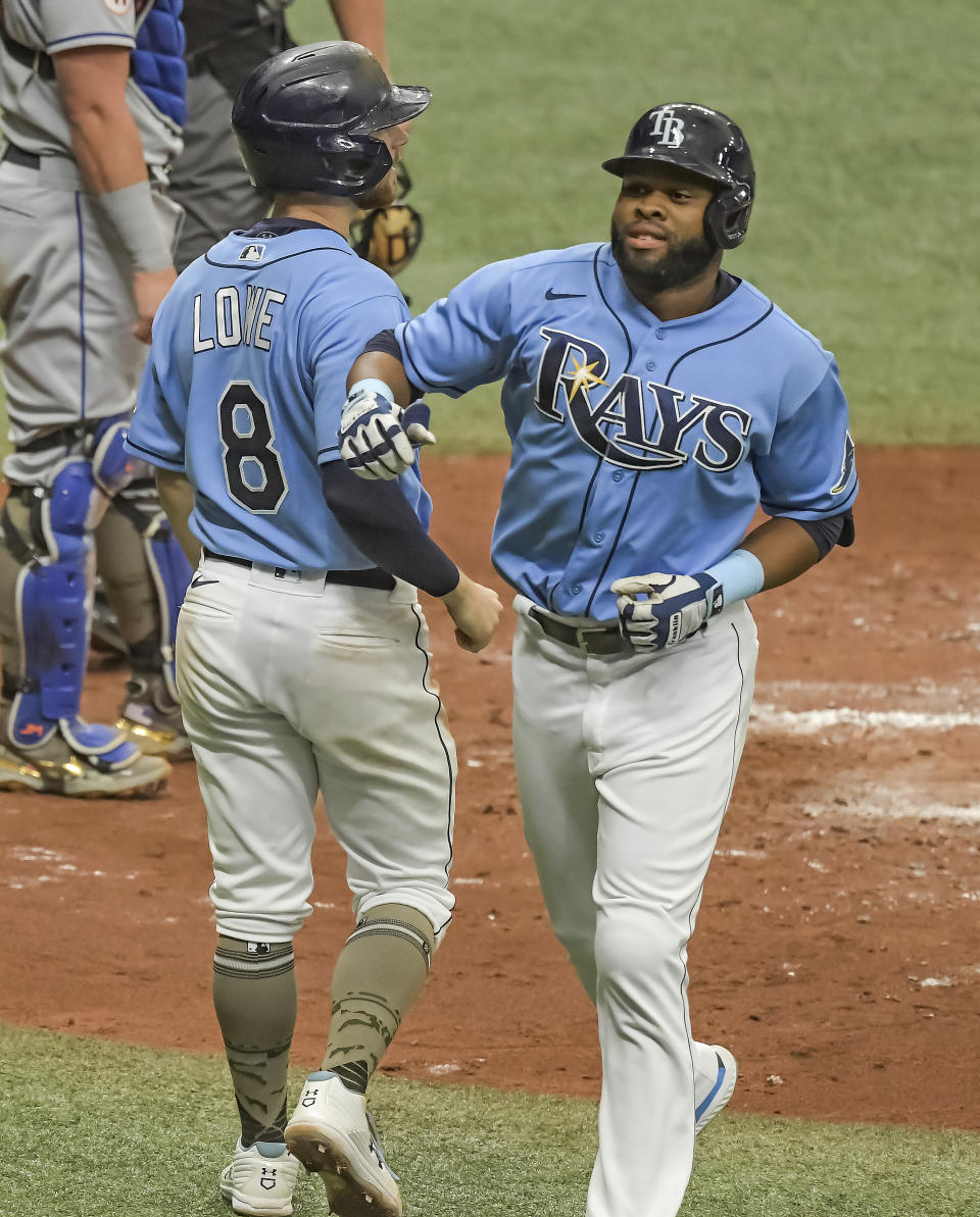 Tampa Bay Rays' Brandon Lowe (8) congratulates Manuel Margot after Margot's two-run home run off New York Mets' Marcus Stroman during the fourth inning of a baseball game Sunday, May 16, 2021, in St. Petersburg, Fla. (AP Photo/Steve Nesius)