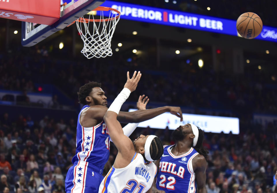 Philadelphia 76ers forward Paul Reed, left, blocks a shot by Oklahoma City Thunder guard Aaron Wiggins during the second half of an NBA basketball game Saturday, Nov. 25, 2023, in Oklahoma City. (AP Photo/Kyle Phillips)