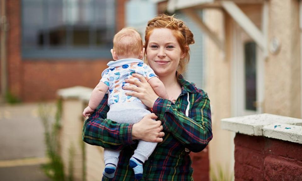 British red headed female in street holding son