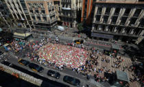 People gather at an impromptu memorial where a van crashed into pedestrians at Las Ramblas in Barcelona, Spain, August 22, 2017. REUTERS/Albert Gea