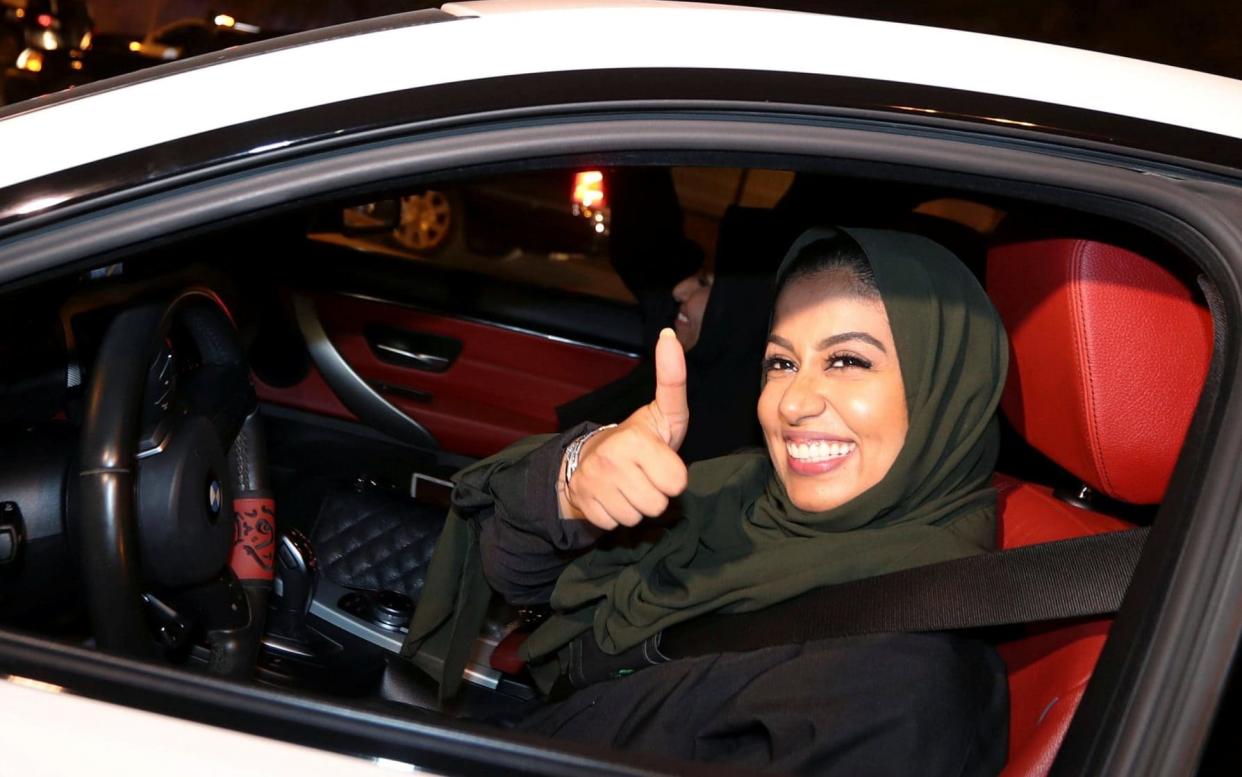 A Saudi woman celebrates as she drives her car in her neighborhood, in Al Khobar, Saudi Arabia, - REUTERS