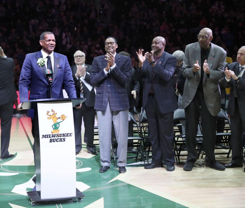Marques Johnson has his number 8 jersey retired during a halftime ceremony on March 24, 2019, with the support of former teammates, from left, Junior Bridgeman, Sidney Moncrief and Bob Lanier.