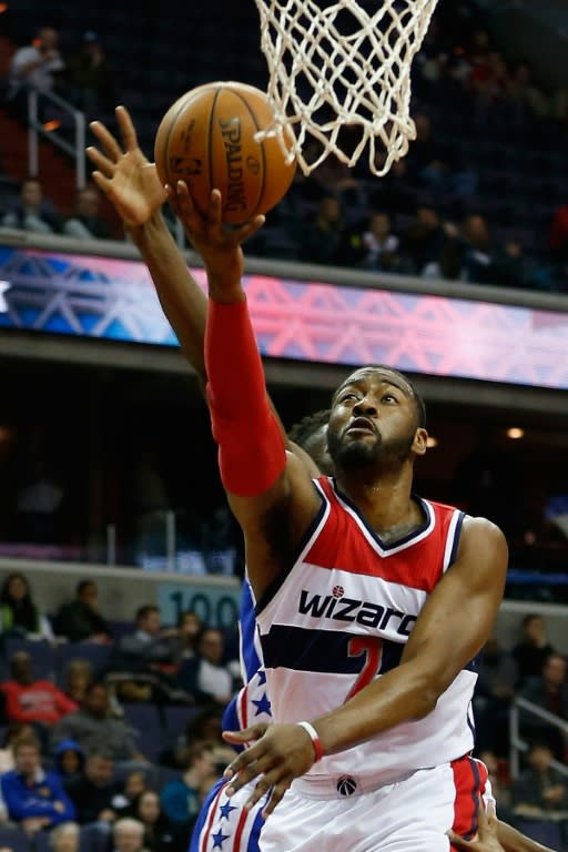 John Wall of the Washington Wizards puts up a shot against the Philadelphia 76ers in the first half at Verizon Center