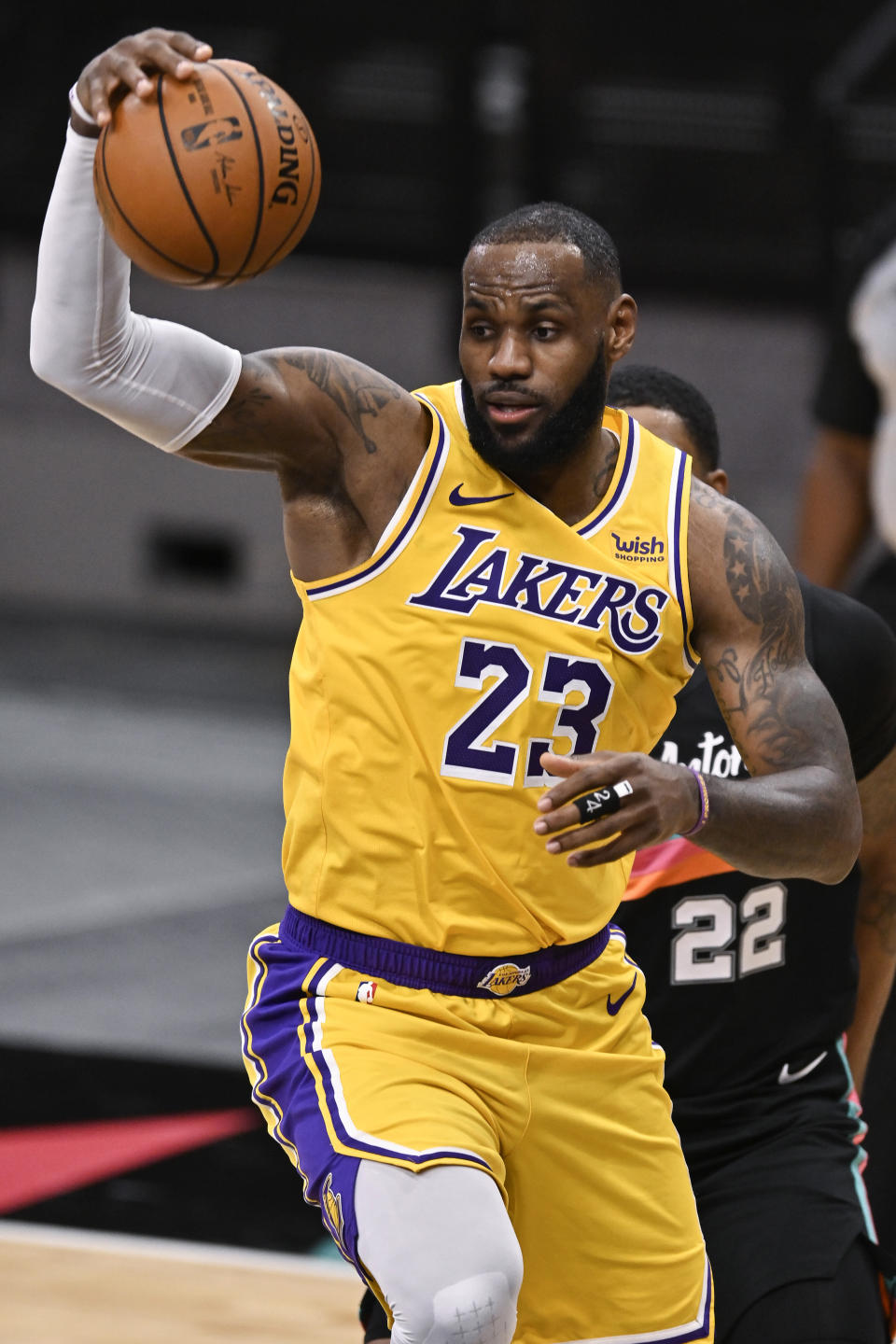 Los Angeles Lakers' LeBron James grabs a rebound during the first half of the team's NBA basketball game against the San Antonio Spurs, Friday, Jan. 1, 2021, in San Antonio. (AP Photo/Darren Abate)