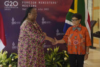 Indonesian Foreign Minister Retno Marsudi, right, greets South African Minister of International Relations and Cooperation Naledi Pandor during their bilateral meeting ahead of the G20 Foreign Ministers' Meeting in Nusa Dua, Bali, Indonesia, Thursday, July 7, 2022. (AP Photo/Dita Alangkara, Pool)