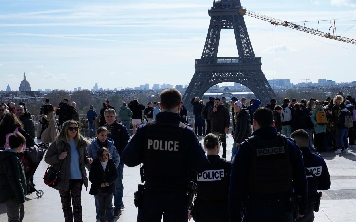 Police officers patrolling Trocadero Square under the Eiffel Tower