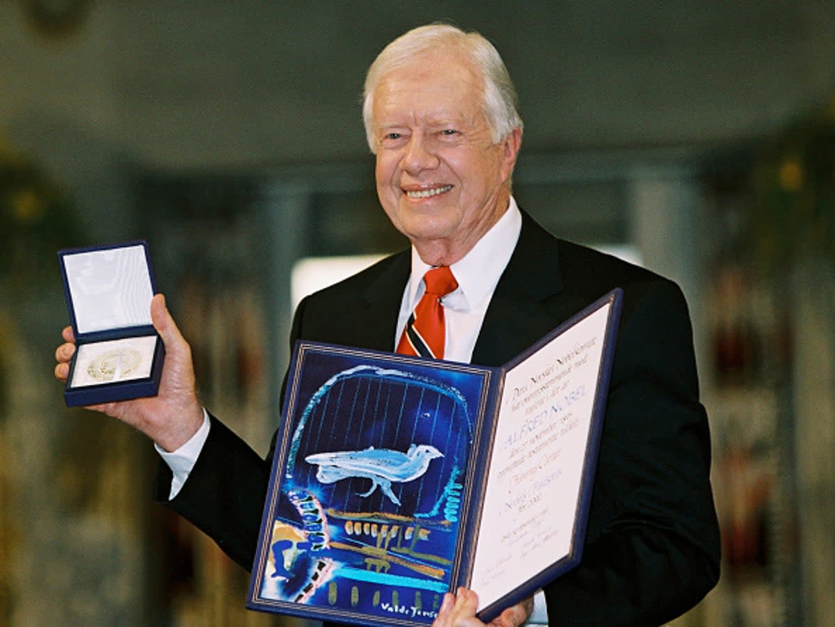  Former president Jimmy Carter holds up his Nobel Peace Prize December 10, 2002 in Oslo, Norway.  His granson said he is no longer awake every day while in hospice care.   (Getty Images)