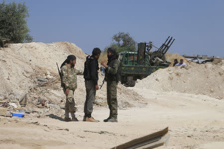 Fighters from a coalition of rebel groups called "Jaish al Fateh", also known as "Army of Fatah" (Conquest Army), talk near Psoncol town after saying they had taken control of it, in the Idlib countryside, Syria June 6, 2015. REUTERS/Mohamad Bayoush/Files