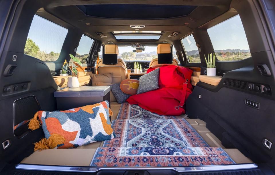 <p>Stripped of its standard second and third rows, this Grand Wagoneer concept comes with a rear-seat entertainment system and space for passengers to relax among bean bags, throw pillows, and a plush carpet. The entire floor has been coated in the same material used for truck bedliners, so spills and things of that nature are no problem.</p>