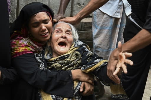 Relatives of victims mourn after a fire tore through apartment blocks in Bangladesh's capital Dhaka, killing dozens of people