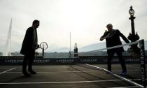 Bjorn Borg of Sweden returns the ball to Switzerland's Roger Federer (L) during a tennis session to promote the Laver Cup tennis tournament on a temporary court on the banks of Lake Geneva in Geneva, Switzerland February 8, 2019. REUTERS/Arnd Wiegmann