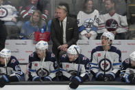 Winnipeg Jets coach Rick Bowness reacts behind players on the bench during the third period of the team's NHL hockey game against the San Jose Sharks in San Jose, Calif., Thursday, Jan. 4, 2024. (AP Photo/Jeff Chiu)
