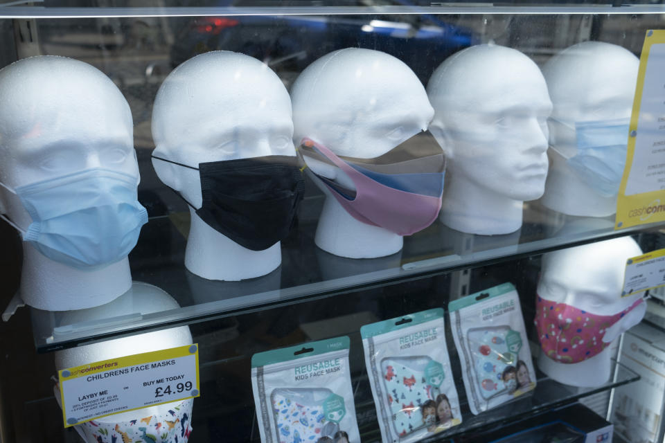 With most shops now open but with retail sales suffering due to the Coronavirus pandemic, face maks for sale on mannequin heads, which became compulsory in shops on the 24th July, go out shopping on Kings Heath High Street on 31st July 2020 in Birmingham, United Kingdom. Coronavirus or Covid-19 is a respiratory illness that has not previously been seen in humans. While much or Europe has been placed into lockdown, the UK government has put in place more stringent rules as part of their long term strategy, and in particular social distancing. (photo by Mike Kemp/In PIctures via Getty Images)
