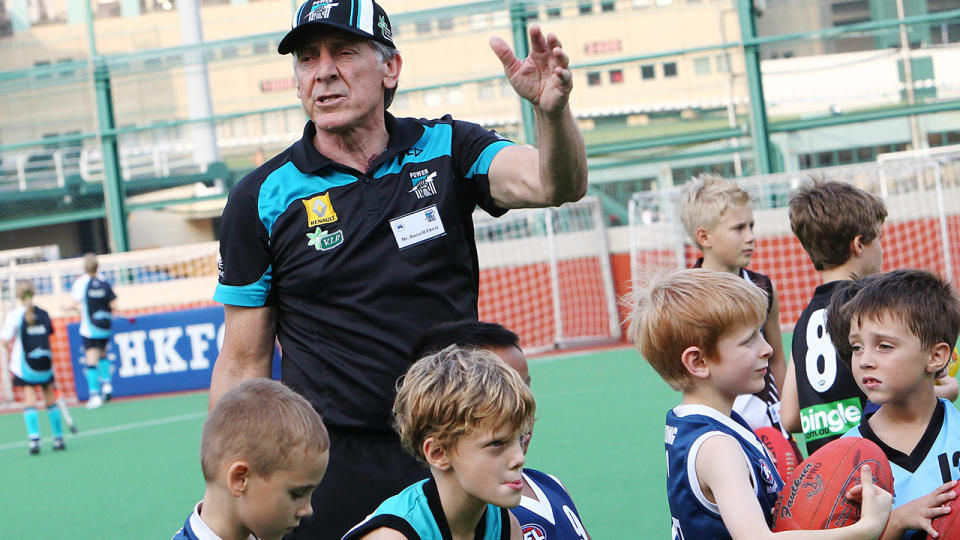 Russell Ebert is pictured coaching a junior AFL clinic in 2013. 