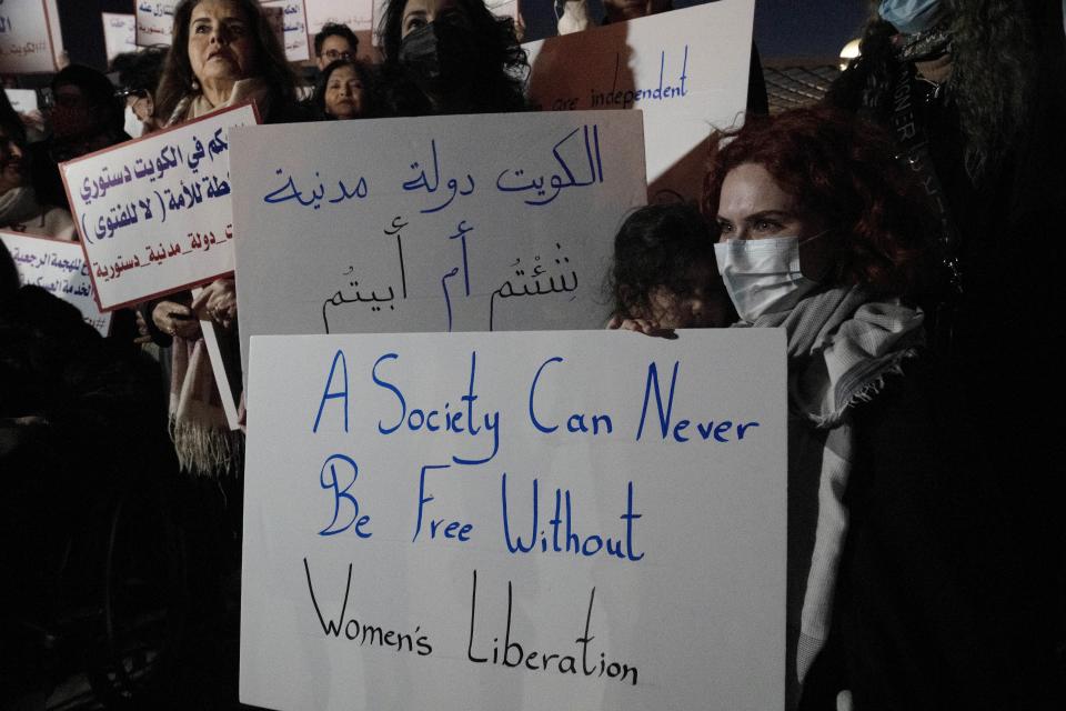 Women's rights activists and their supporters protest outside Kuwait's National Assembly, in Kuwait City, Monday, Feb. 7, 2022. Women might be progressing across the Arab world, but in Kuwait, the guardians of conservative morals have increasingly cracked down on their rights in recent months, prompting activists to take to the streets last week. (AP Photo/Maya Alleruzzo)