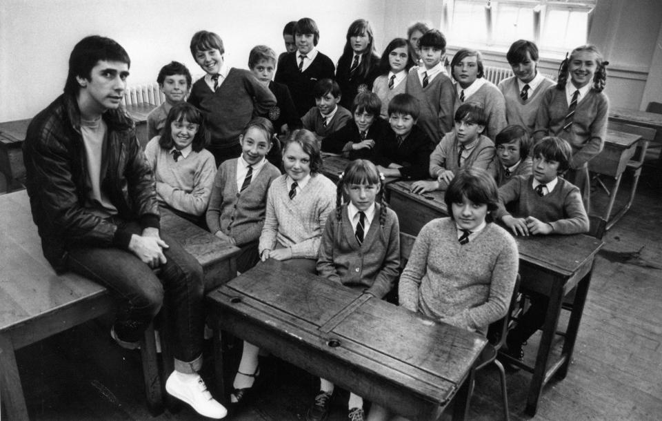 Phil Redmond, television producer and screenwriter known for creating several popular television series such as Grange Hill (BBC One, 1978?2008), Brookside (Channel 4, 1982?2003) and Hollyoaks (Channel 4, 1995 -). Our Picture Shows ... Phil Redmond chats with a class of students at New Heys Comprehensive, Allerton, Liverpool, Thursday 15th July 1982.