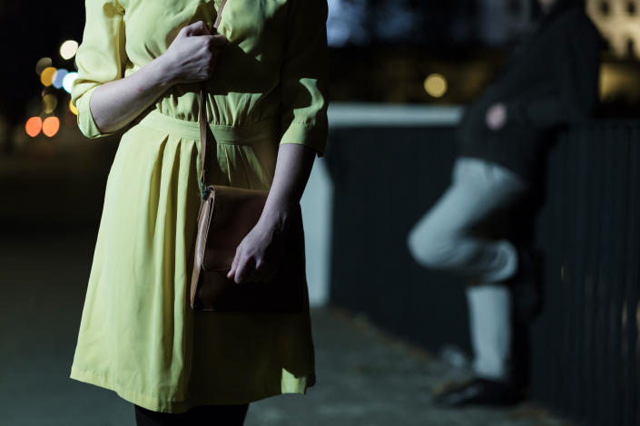 A woman with a man behind her. (PHOTO: Getty Images)