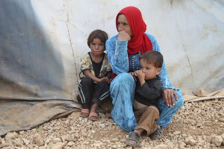 Syrian refugees from Raqqa rest near their tents in the Bekaa valley, Lebanon October 19, 2015. REUTERS/Alia Haju