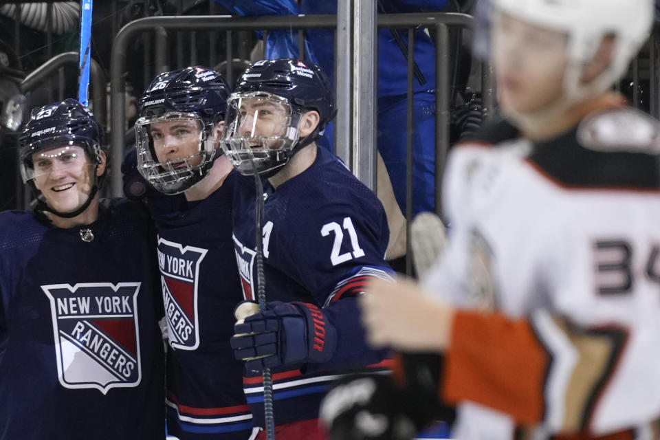 New York Rangers' Jimmy Vesey, second from left, celebrates his goal against the Anaheim Ducks with Adam Fox, left, and Barclay Goodrow during the second period of an NHL hockey game, Friday, Dec. 15, 2023, in New York. (AP Photo/Seth Wenig)