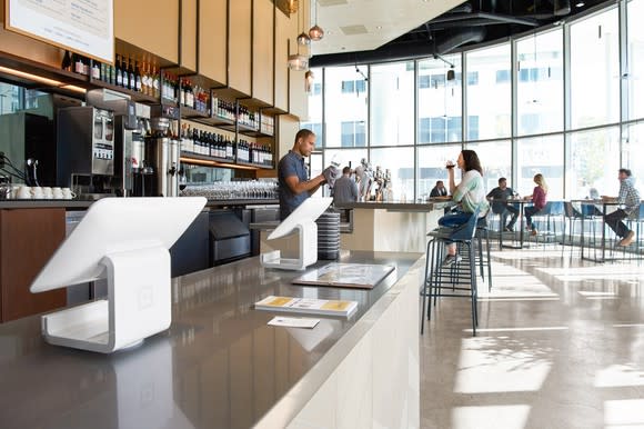 A restaurant countertop featuring Square payment terminals.