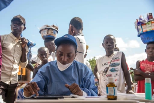 Nurses working with the World Health Organization prepare to administer vaccines at the town all of Mbandaka