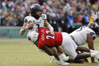 Cincinnati quarterback Evan Prater is sacked by Louisville's Yasir Abdullah during the second quarter of the Fenway Bowl NCAA college football game at Fenway Park Saturday, Dec. 17, 2022, in Boston. (AP Photo/Winslow Townson)