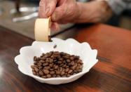 Shizuo Mori, the owner of Heckeln coffee shop prepares to grind coffee beans at his shop in Tokyo