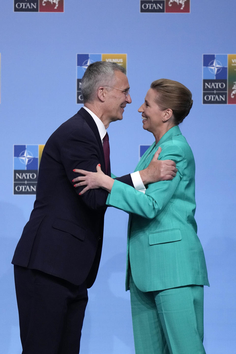 NATO Secretary General Jens Stoltenberg, left, greets Denmark's Prime Minister Mette Frederiksen during arrivals for a NATO summit in Vilnius, Lithuania, Tuesday, July 11, 2023. NATO's summit began Tuesday with fresh momentum after Turkey withdrew its objections to Sweden joining the alliance, a step toward the unity that Western leaders have been eager to demonstrate in the face of Russia's invasion of Ukraine. (AP Photo/Pavel Golovkin)