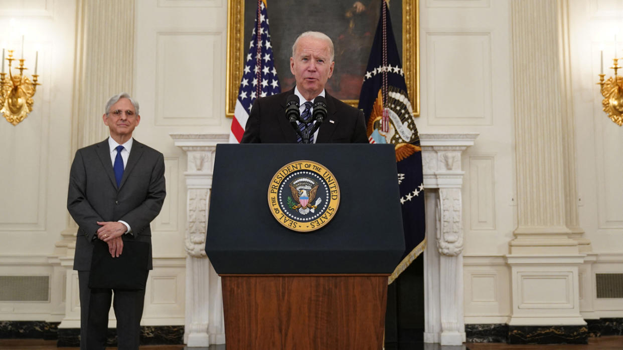 Merrick Garland, left, and Joe Biden