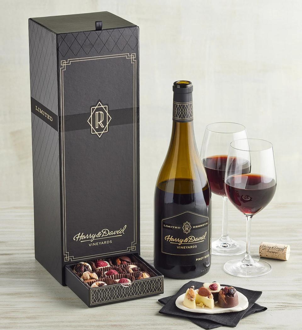 bottle of red wine next to box of chocolates