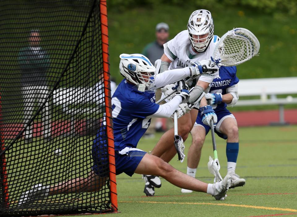 Pleasantville's Daniel Picart (10) gets a shot by Bronxville goalie Luke Arrighi (22) for a first half goal during boys lacrosse action at Pleasantville High School  May 4, 2023. 