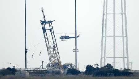 A helicopter does reconnaissance over the launch pad at NASA Wallops Flight Facility in Virginia October 29, 2014. REUTERS/Kevin Lamarque