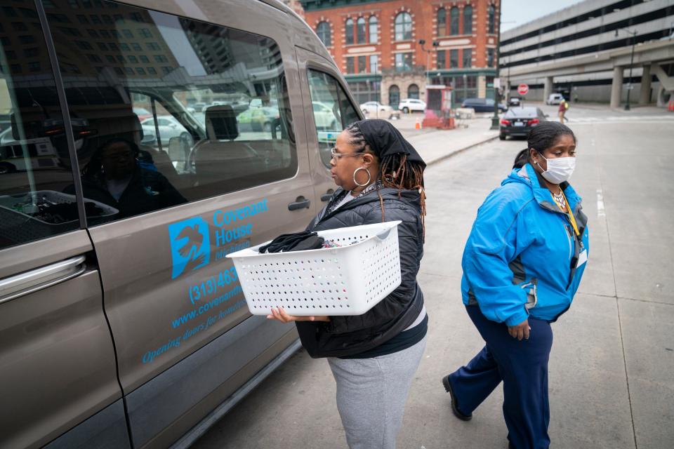 Charquiathia Rogers, 50, of Detroit, left, and outreach manager Stephanie Taylor, 50, of Detroit, ride together in the Covenant House Michigan outreach van in hopes of educating vulnerable and homeless youths about the services they offer as they prepare to hand out essentials like hats, gloves and snacks to anyone who needs such items outside of the Rosa Parks Transit Center on Dec. 9, 2022, in Detroit.