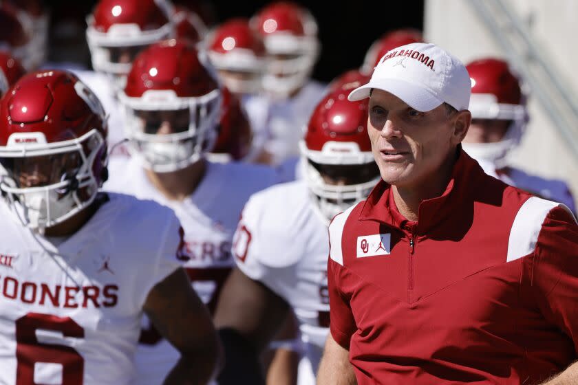 Oklahoma coach Brent Venables leads his team onto the field before facing TCU