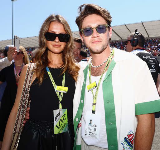 Mark Thompson/Getty Niall Horan and Amelia Woolley pose for a photo on the grid during the F1 Grand Prix of France at Circuit Paul Ricard on July 24, 2022 in Le Castellet, France.