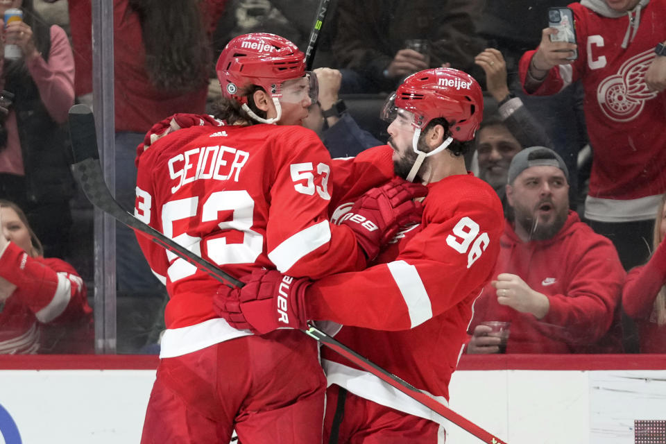 Detroit Red Wings defenseman Jake Walman (96) celebrates his goal with Moritz Seider (53) in the second period of an NHL hockey game against the Seattle Kraken Thursday, March 2, 2023, in Detroit. (AP Photo/Paul Sancya)