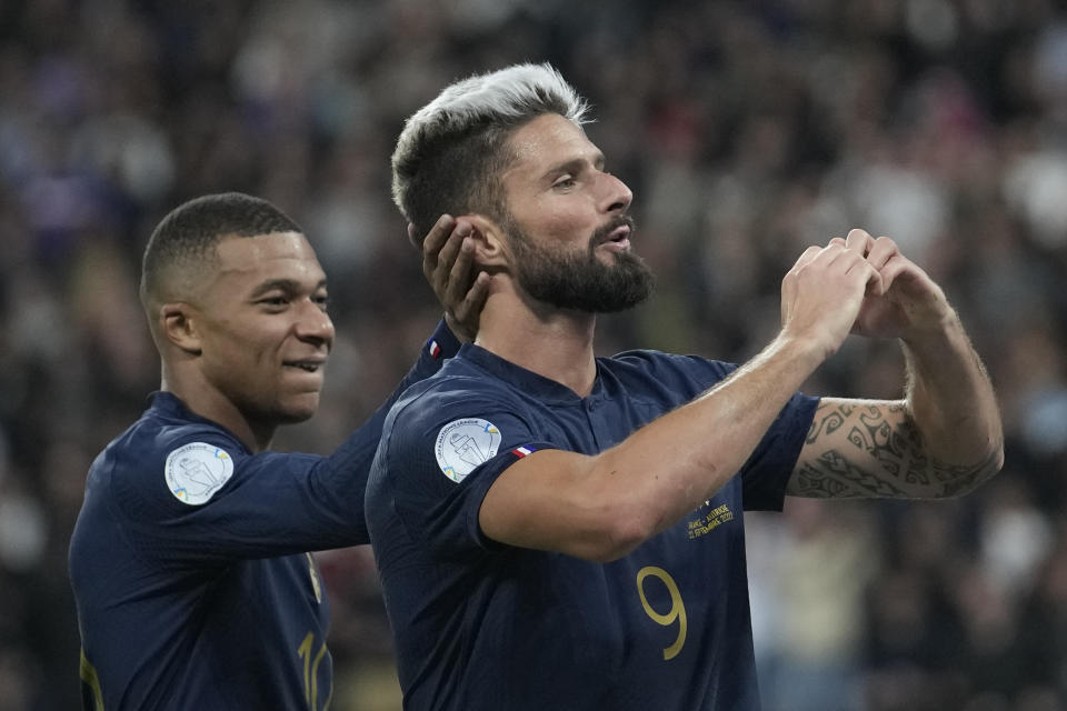 France's Olivier Giroud, right, and France's Kylian Mbappe celebrate after Giroud scored his side's second goal during the UEFA Nations League soccer match between France and Austria at the Stade de France stadium in Saint Denis, outside Paris, France,Thursday, Sept. 22, 2022. (AP Photo/Christophe Ena)
