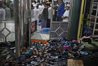Footwear are left outside as people perform perform an evening prayer called 'tarawih' during the first evening of the holy fasting month of Ramadan, at a mosque in Jakarta, Indonesia, Monday, April 12, 2021. (AP Photo/Dita Alangkara)