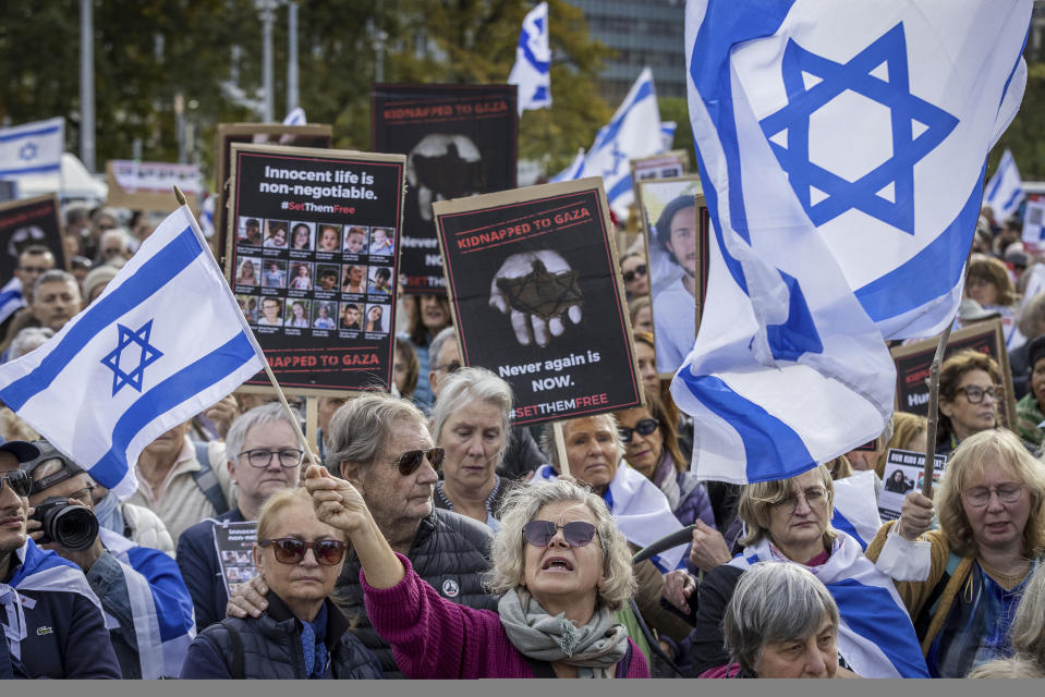 FILE - Protesters hold banners with hostages' pictures and Israel flags during a gathering next to the European headquarters of the United Nations in Geneva, Switzerland, on Oct. 22, 2023. Antisemitism is spiking across Europe after Hamas' Oct. 7 massacre and Israel's bombardment of Gaza, worrying Jews from London to Geneva and Berlin. (Magali Girardin/Keystone via AP, File)