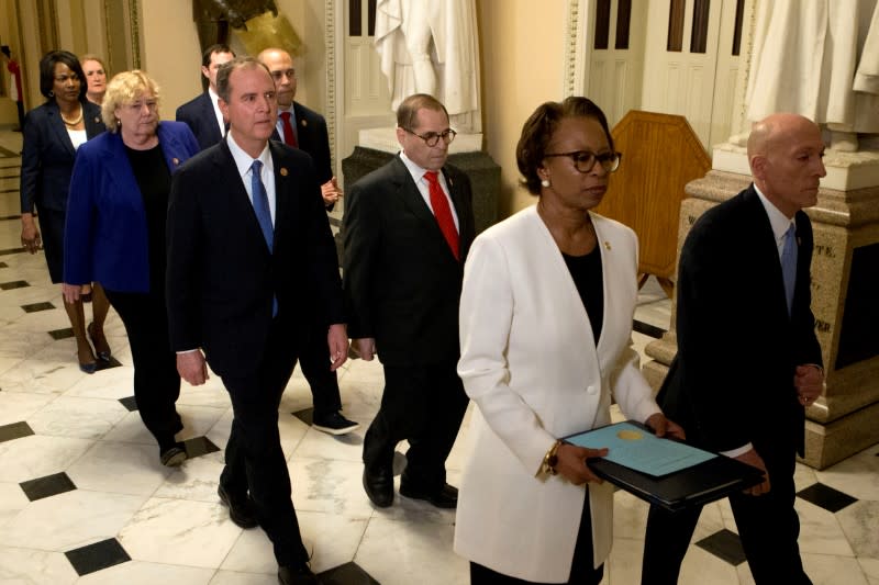 FILE PHOTO: House Sergeant at Arms Irving and Clerk of the House Johnson deliver the articles of impeachment against President Trump to Secretary of the Senate on Capitol Hill in Washington